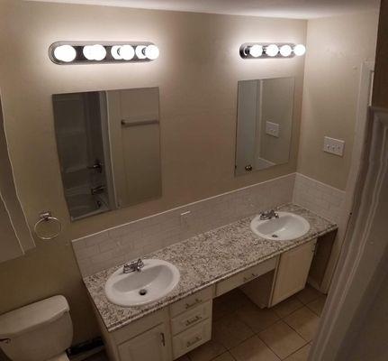 Bathroom remodel completed for a happy customer! Dual sinks, two mirrors, subway tile backsplash and a new countertop.