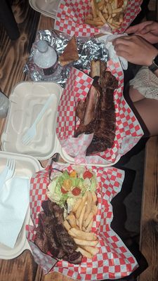 Ribs and steak plate with fries and salad