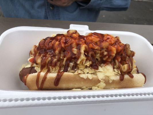 Chief hot dog.  Mac and cheese, crushed potato chips, pickle, bar b que sauce and hot sauce.