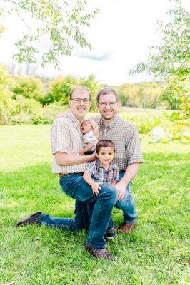 A family welcomes their newborn son during a family photography session.