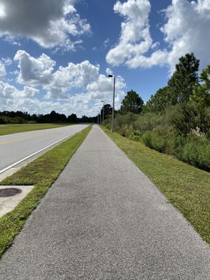 From the parking lot you need to walk up Lizard's Tail road and then on this sidewalk until the road curves to get to the path.