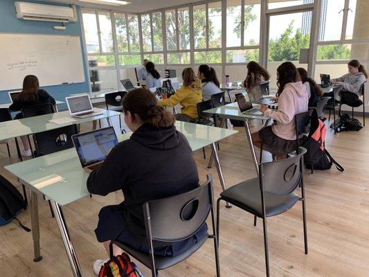 Girls studying Halacha with Rabbi Richler.