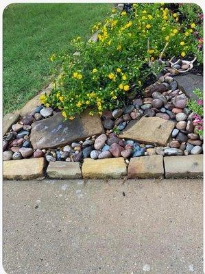 River rock in front flowerbed