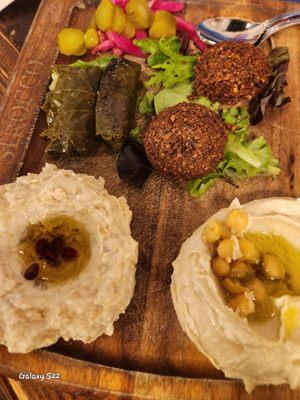 Mediterranean mixed appetizers: hummus, abganush, falafel, grape leaves and pickled veggies. You can select your own favorites!