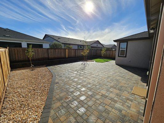 This was a bare backyard, installed pavers, artificial turf, and retaining wall.