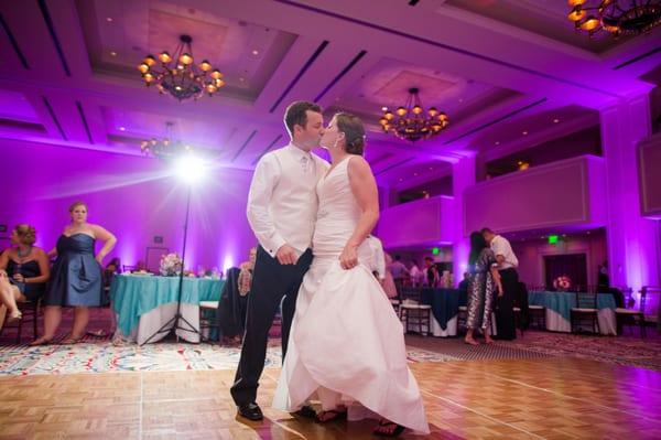 First Kiss with purple uplights. Photo credit Katelyn James Photography.