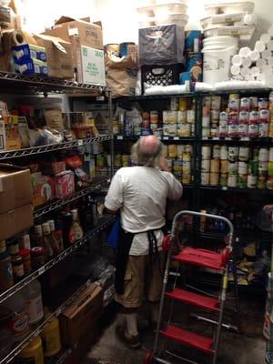 Ron putting donations away in the dry pantry