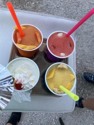 Smoothies top left mango papaya, top right strawberry banana, bottom left pina colada, bottom right mango banana