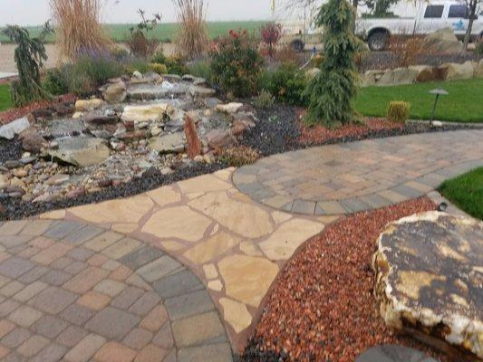 Paver path next to a waterfall