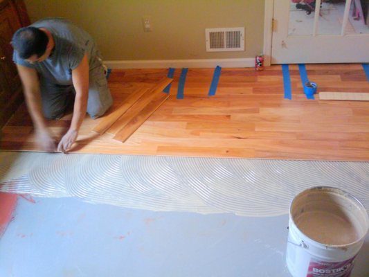 Engineered hardwood floors glued down on concrete slab