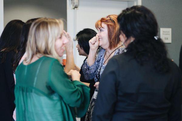 Women Excited and talking at Excellence Performance Seminar.