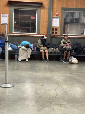 Some of everybody sitting near that dirty window. The roach motel of travel.