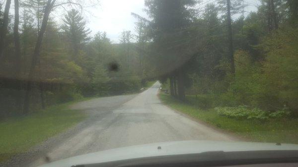 The small stone pad on the left is the only parking area.