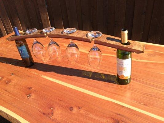 Wine glass display with two bottles of wine; made from wine barrell stave