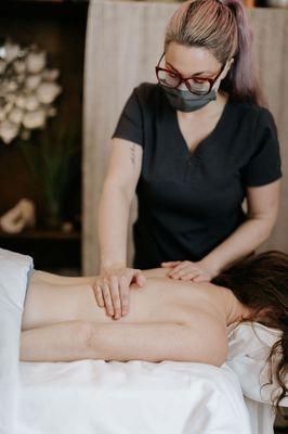 A woman receiving massage therapy treatment.