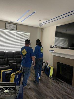 Employees marking water areas and setting up the water removal equipment