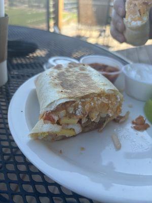 Half of a sausage breakfast burrito