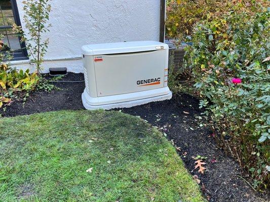 26kw Generac generator set on a GenPad concrete base.