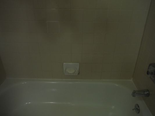 Before grout cleaning and repair at our rental.