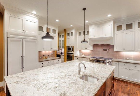 Beautiful modern designed kitchen with modern lighting, painted walls and hardwood floor.