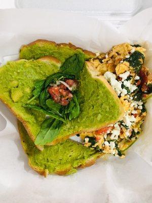 Green Monster. Avocado toast and eggs with spinach tomato and feta