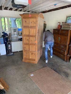 Large armoire getting wrapped up to get loaded