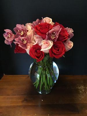 Roses and cymbidium orchids look beautiful together.