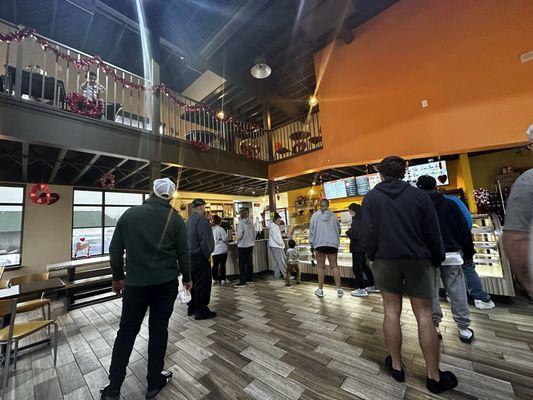 The inside of Murray donuts. There are stairs to the left of the picture that lead to tables upstairs where you can view the town