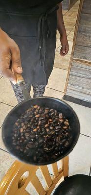 The hostess roasting coffee beans.