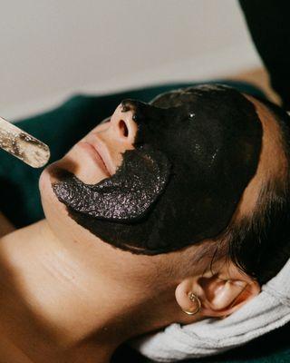 Charcoal jelly mask during an Enhanced Member Facial.