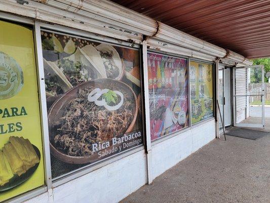 Front of the Tortilleria San Juanita - old-school roll-up garage window protectors.