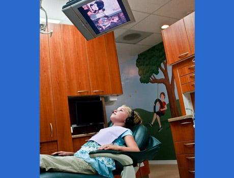 Overhead TVs over treatment chairs.