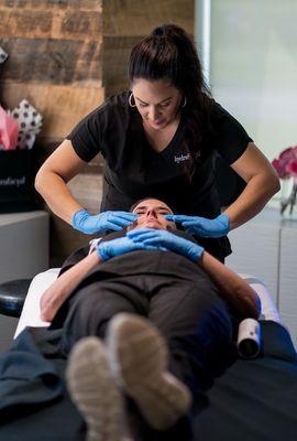 The HydraFacial Master Class!  Here Melissa Kinsey is beginning a Lymphatic Drainage treatment which is included in all our HydraFacials!