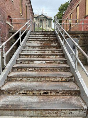 View up rusted stairway to courthouse