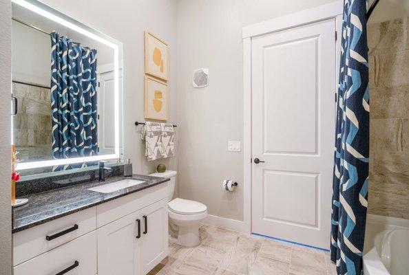 spa-like bathroom with backlit mirrors