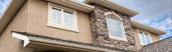 Stucco repair, Tex Cote exterior, vinyl replacement windows and natural stone facade