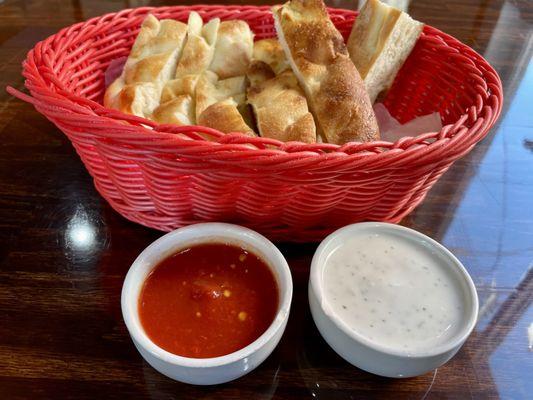 Fresh warm bread with dipping sauces.