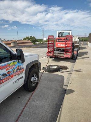 Changing a blown trailer tire on a road call