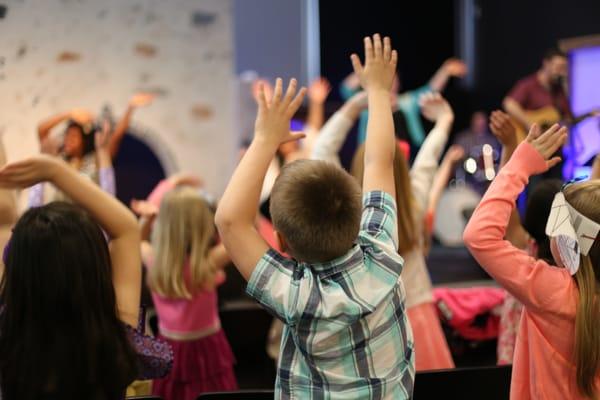 Kids enjoying the morning program with fun songs and hand motions.