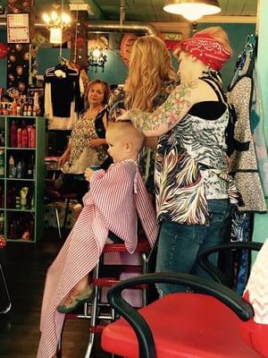 My youngest son (2 1/2) having a cold drink while getting his hair cut by Amy.