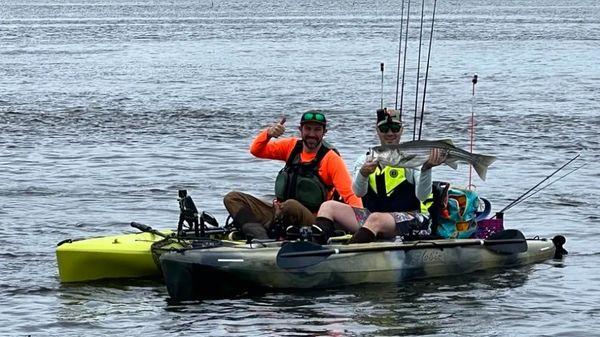 Guide Josh Rayner and Happy client with a solid Connecticut River striped bass.