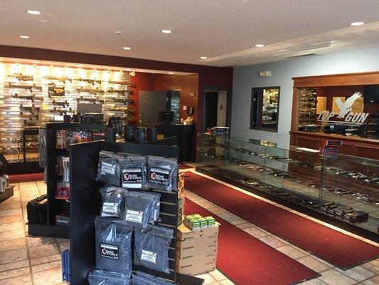 Gun Store showroom with handguns, rifles, ammo, holsters and accessories for sale.