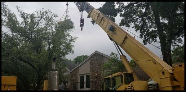 With help from crane system we hoist the AC unit high into the air avoiding trees and roof lines