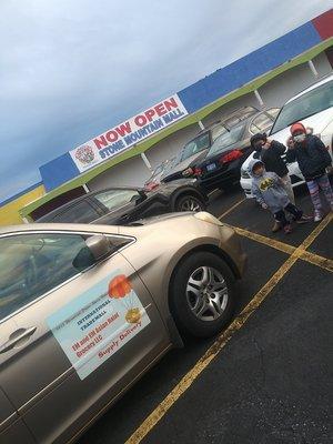 Front of the mall along with the delivery car