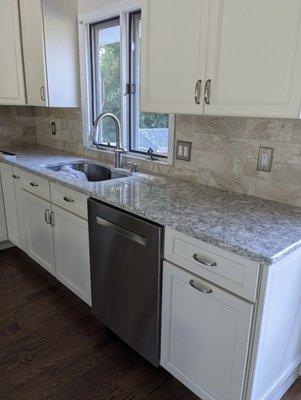 Complete kitchen remodel with new cabinets, backsplash, hardwood floors, and countertop