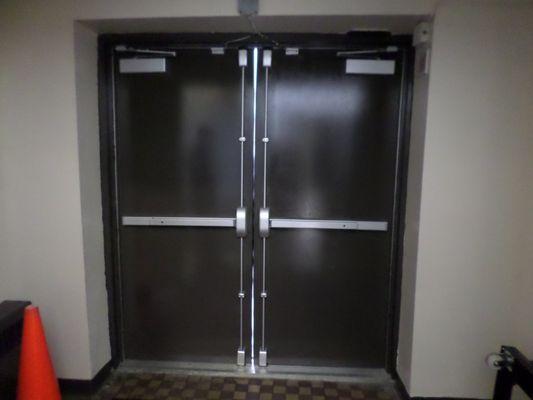 Pair of Hollow Metal Exit Doors with Panic Bars and Door Closers