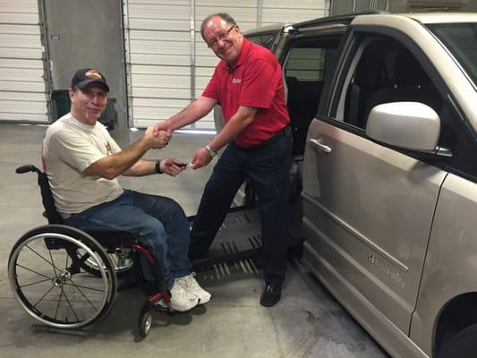 Michael T taking the keys to his new wheelchair accessible van