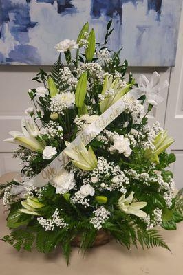 A very elegant funeral arrangement of expensive Oriental Lilies but still within your budget .