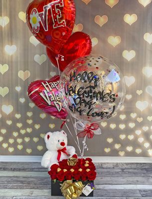 Charming arrangement of 24 boxed roses with personalized static balloon and chocolates! It is a design with roses of various sizes where