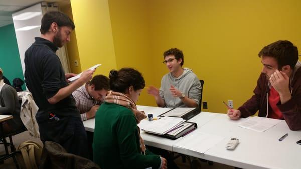 Jeff Glazer checks in on a team during an LSAT workshop.